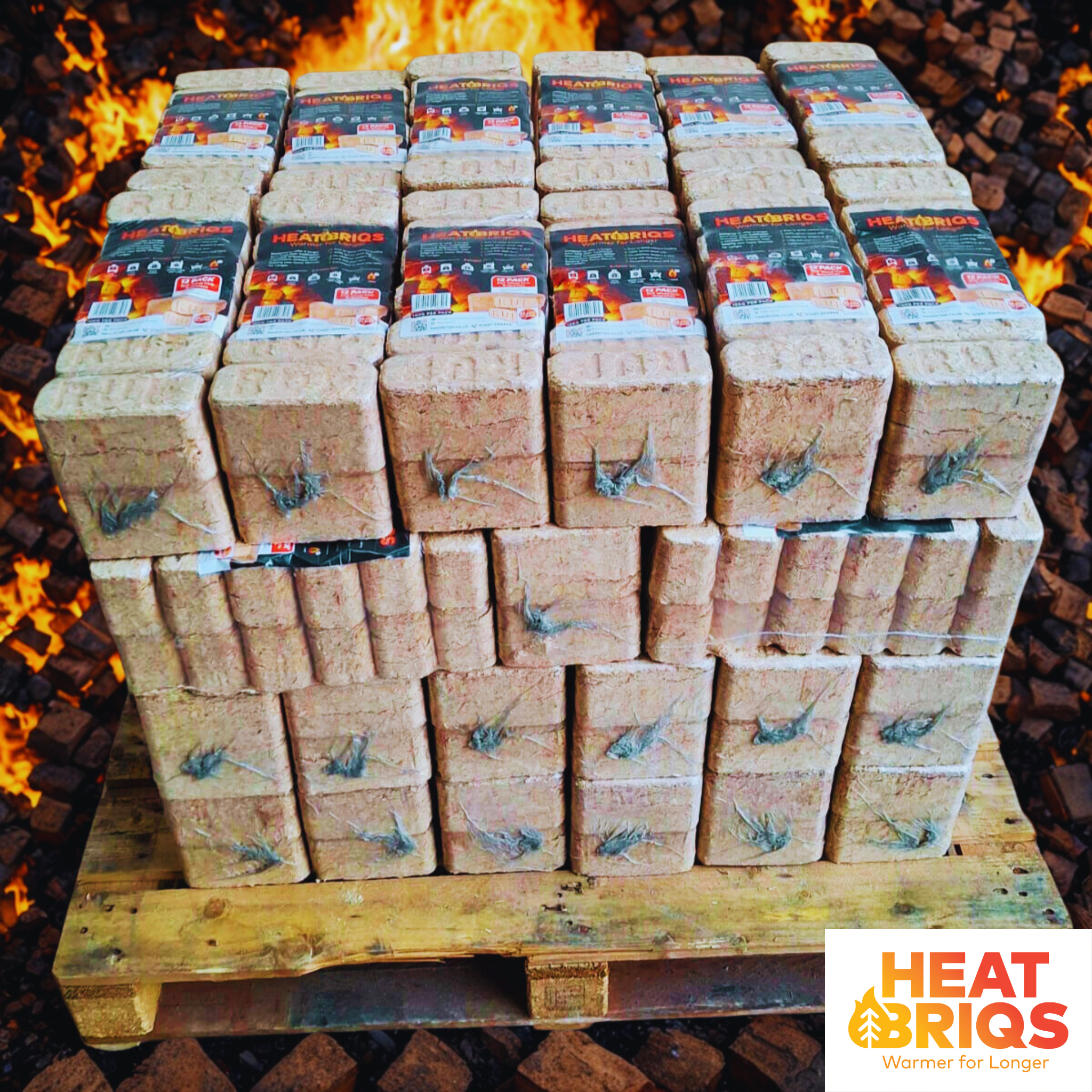 Half pallet of HeatBriqs Firewood Briquettes with fire and flames in the background.