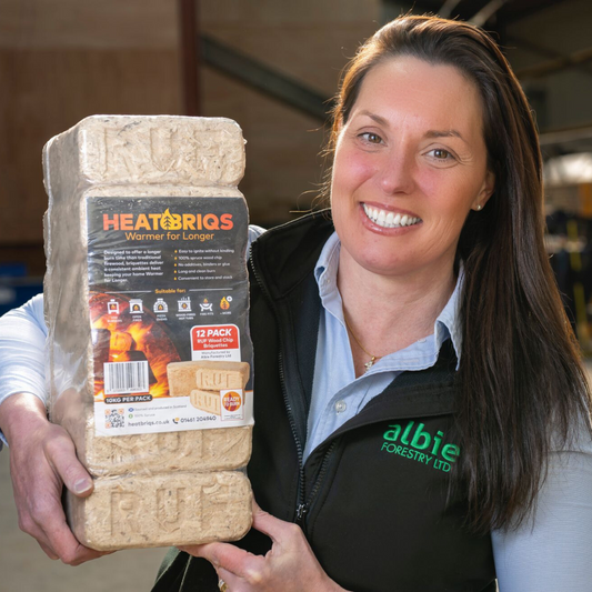 Female person holding a pack of HeatBriqs Firewood Briquettes.